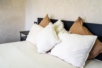 a pile of pillows sitting on top of a bed at Romilli atlas in Sbiti