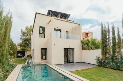 a house with a pool in front of it at Romilli atlas in Sbiti
