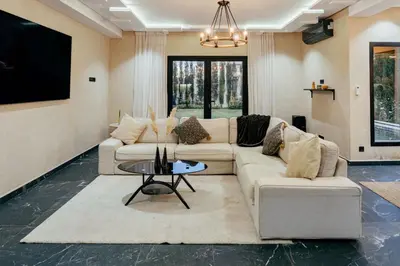 a living room with two couches and a tv at Romilli atlas in Sbiti