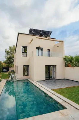 a house with a swimming pool in front of it at Romilli atlas in Sbiti