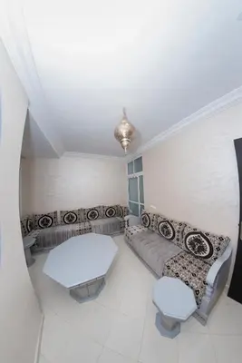 a living room with a couch and a table at Royal Deluxe Fez in Fès