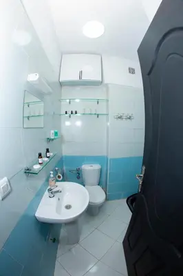 a bathroom with a white sink and a toilet at Royal Deluxe Fez in Fès