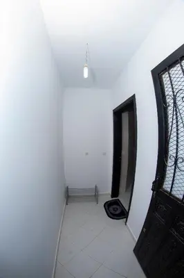 an empty hallway with a door and a window at Royal Deluxe Fez in Fès