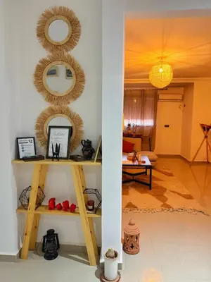 a living room with a shelf with a mirror at Happiness Apartment in Ouarzazate