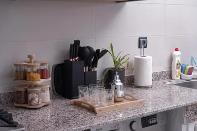 a kitchen counter with glasses on a cutting board at Happiness Apartment in Ouarzazate