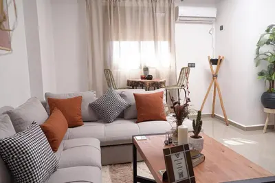 a living room with a couch and a table at Happiness Apartment in Ouarzazate
