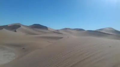 a group of sand dunes in the desert at Bivouac Dune Iriki in Foum Zguid