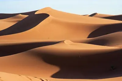 a group of dunes in the desert at Bivouac Dune Iriki in Foum Zguid