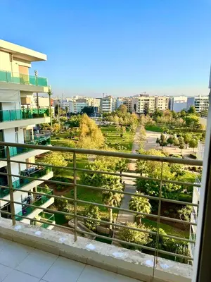 a view of a park from a balcony of a building at Appartement avec vue sur parc et Wifi 100 Mo in Fès