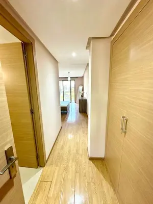 an empty hallway with a door and a room at Appartement avec vue sur parc et Wifi 100 Mo in Fès