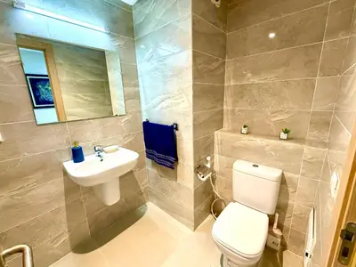 a bathroom with a white toilet and a sink at Appartement avec vue sur parc et Wifi 100 Mo in Fès