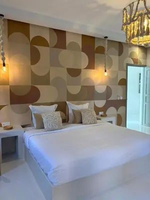 a large white bed in a room with a wall at Villa Loaïa in Marrakech