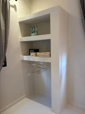 a white walk in closet with white shelves at Villa Loaïa in Marrakech