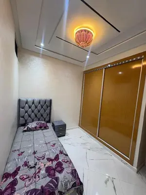 a bedroom with a bed and a glass door at Home sweet home in Fès