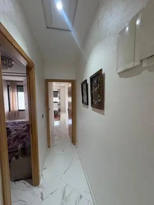 a hallway with white marble floors and a ceiling at Home sweet home in Fès