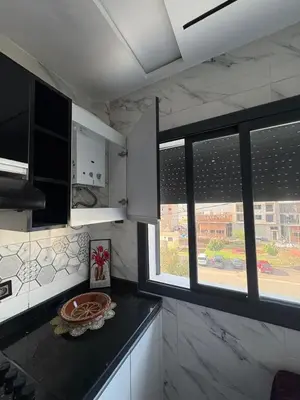 a kitchen with a counter top and a window at Home sweet home in Fès