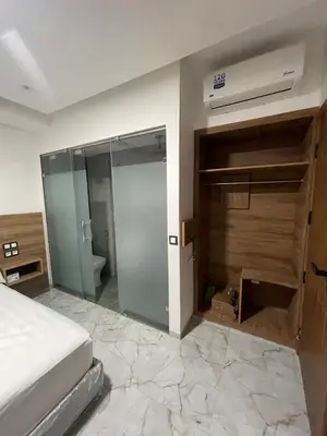 a bedroom with a bed and a sliding glass door at Hôtel kairouan in Fès