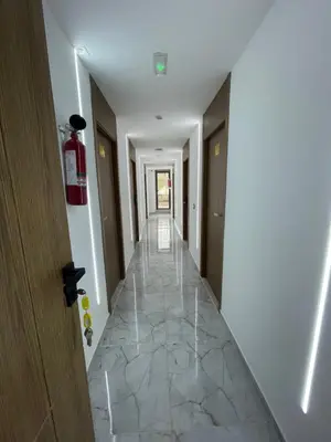 a hallway of a hotel with a tile floor at Hôtel kairouan in Fès