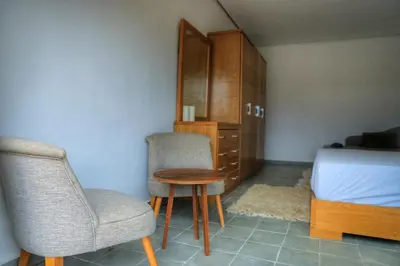 a bedroom with a bed and a table and chairs at Le Clos des Oliviers Marrakech Villa & Piscine in Marrakech