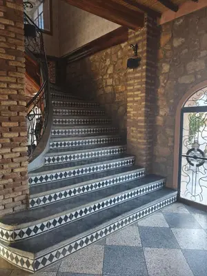 a set of stairs in a building with a window at Hotel El Golla in Er Rachidia