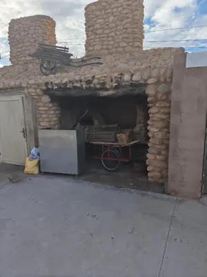 a brick oven with a bike inside of it at Hotel El Golla in Er Rachidia