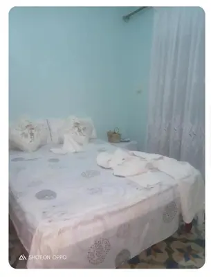 a bed with white sheets and pillows in a room at fes city in Fès