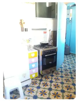 a kitchen with a stove and a tile floor at fes city in Fès