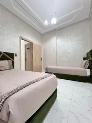 two beds in a room with white walls at White Cactus in Meknès