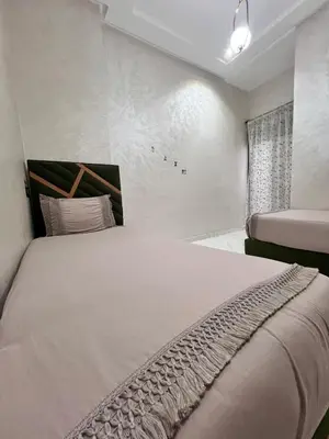 a bedroom with a large bed and a window at White Cactus in Meknès