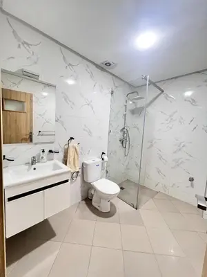 a bathroom with a toilet and a shower and a sink at White Cactus in Meknès