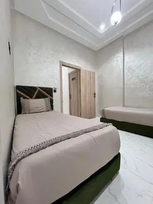 a bedroom with a king sized bed and a tub at White Cactus in Meknès