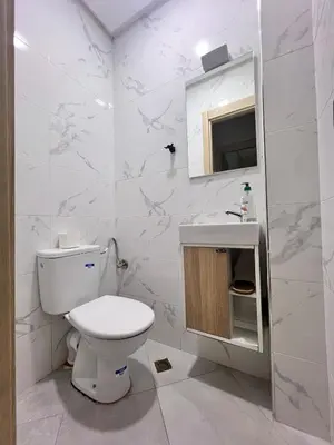 a white bathroom with a toilet and a sink at White Cactus in Meknès
