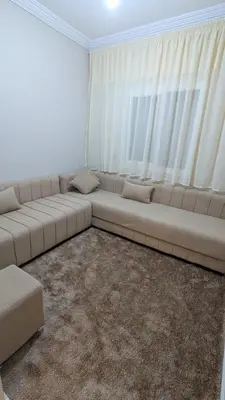 a white couch in a room with a large window at NAYA apartment in Fès