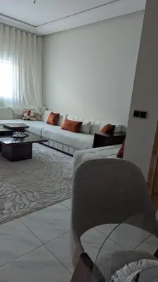 a living room with a couch and a table at NAYA apartment in Fès