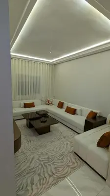 a living room with a couch and a table at NAYA apartment in Fès