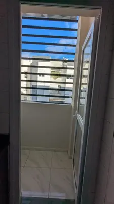 a bathroom door with a window with a view of a building at NAYA apartment in Fès
