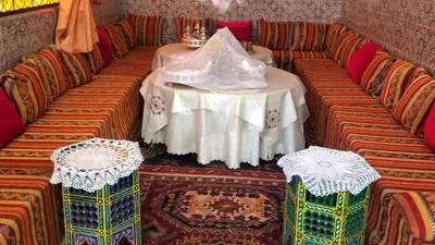 a table and chairs in a room with a table and chairs at Kasbat Taslit in Ouarzazate