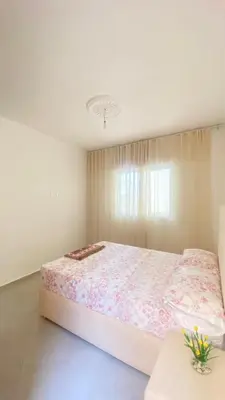 a white bedroom with a large bed in a room at manar immobilier Appart Msnana Golf in Oulad Akkou