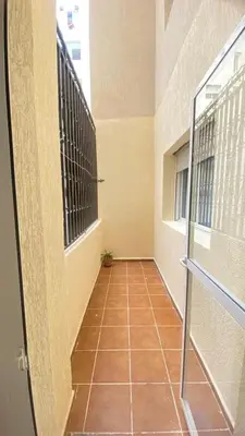 a hallway with a glass door and a tile floor at manar immobilier Appart Msnana Golf in Oulad Akkou