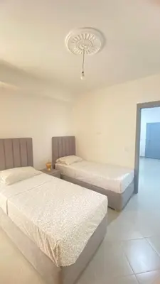 a bedroom with two beds and a ceiling at manar immobilier Appart Msnana Golf in Oulad Akkou