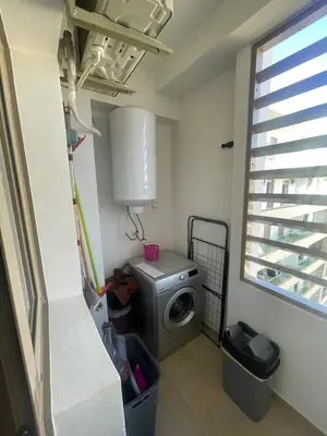 a laundry room with a washing machine and a window at Luxury two bedroom apartment Prestigia Fez in Fès