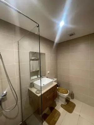 a bathroom with a shower and a sink and a toilet at Luxury two bedroom apartment Prestigia Fez in Fès