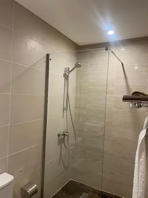 a shower with a glass door in a bathroom at Luxury two bedroom apartment Prestigia Fez in Fès