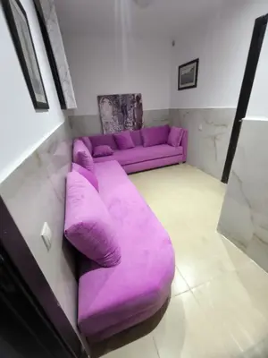 a purple couch sitting in a living room at villa Les Jardins D'atlas in Oulad Akkou