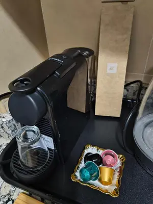 a black toaster sitting on a counter next to a box at villa Les Jardins D'atlas in Oulad Akkou
