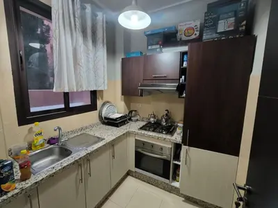 a small kitchen with a sink and a stove at villa Les Jardins D'atlas in Oulad Akkou