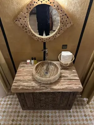 a bathroom counter with a sink and a mirror at Dunes Luxury Lodge in Merzouga