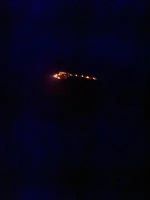 a city at night with lights in the distance at Merzouga Outdoors Private Nomad Expedition in Merzouga