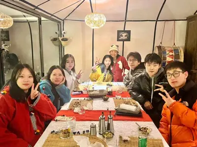 a group of people sitting at a table at Merzouga Luxury Camp in Merzouga