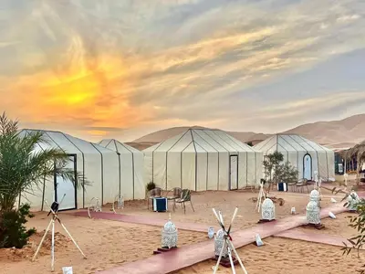 a rendering of a desert camp with tents at Merzouga Luxury Camp in Merzouga